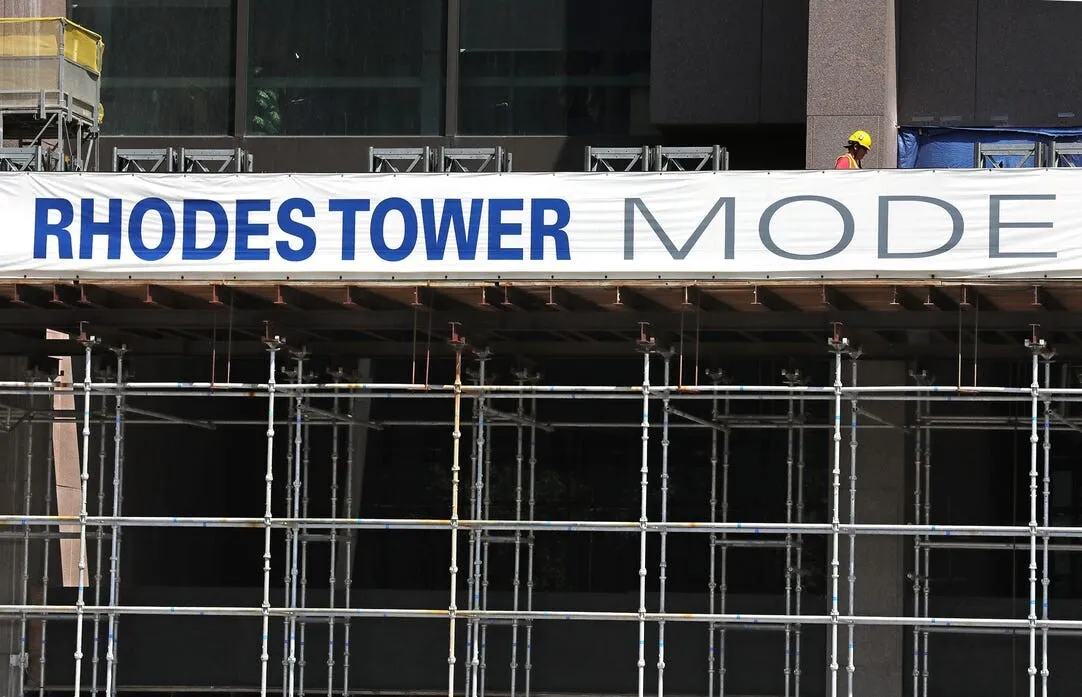 A worker is seen on Thursday, July 21, 2021, above the scaffolding at the Rhodes Tower which has undergone modernization