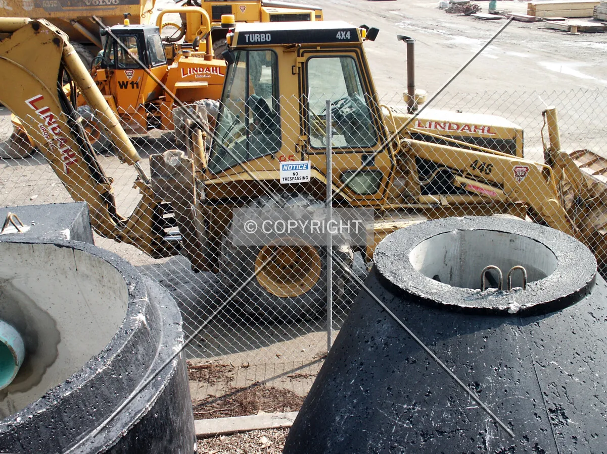 Construction equipment and pipe sections by the northwest corner