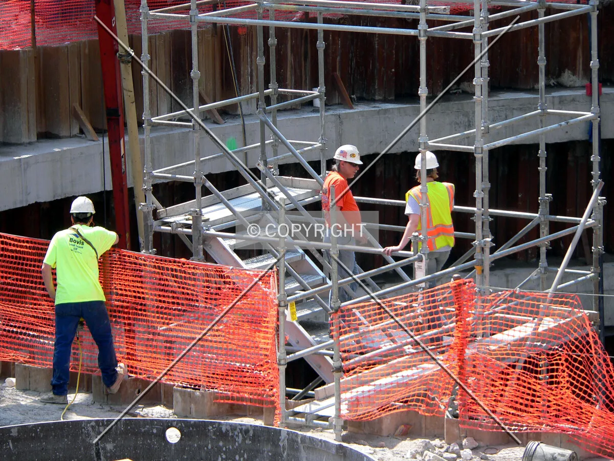 Workers around the stairs that lead to the bottom of the core hole