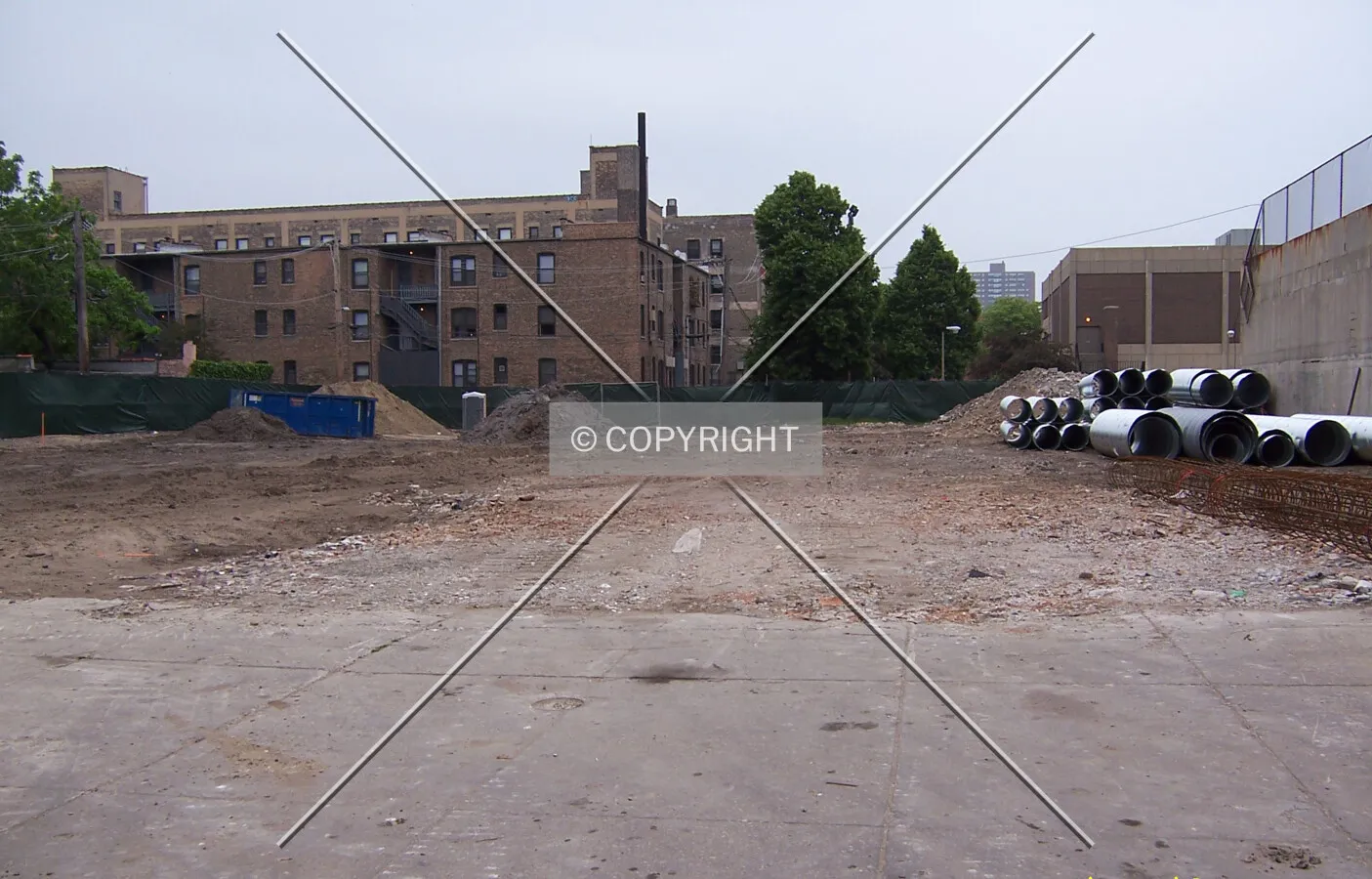 Looking north into the site from Grace Street. Caisson liners and rebar cages lie along the eastern edge of the site