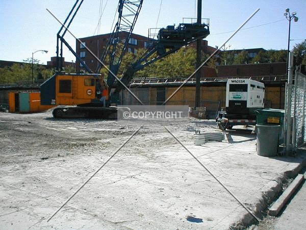 Foundation work begins with the drilling of caissons on the northwest corner of the site