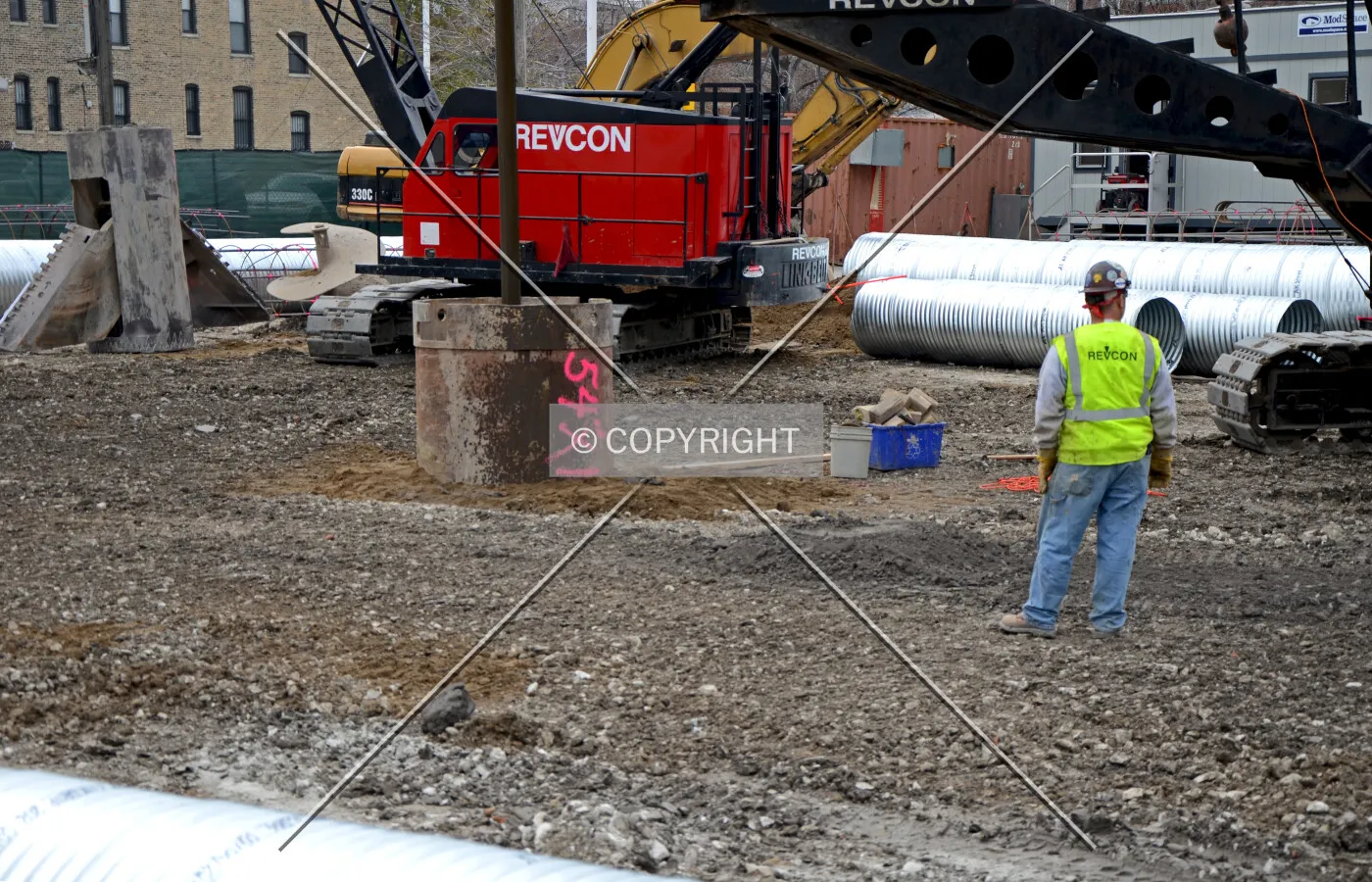 Drill rig using a lowered bell bucket to flair out the bottom of a caisson shaft. November 7, 2012.