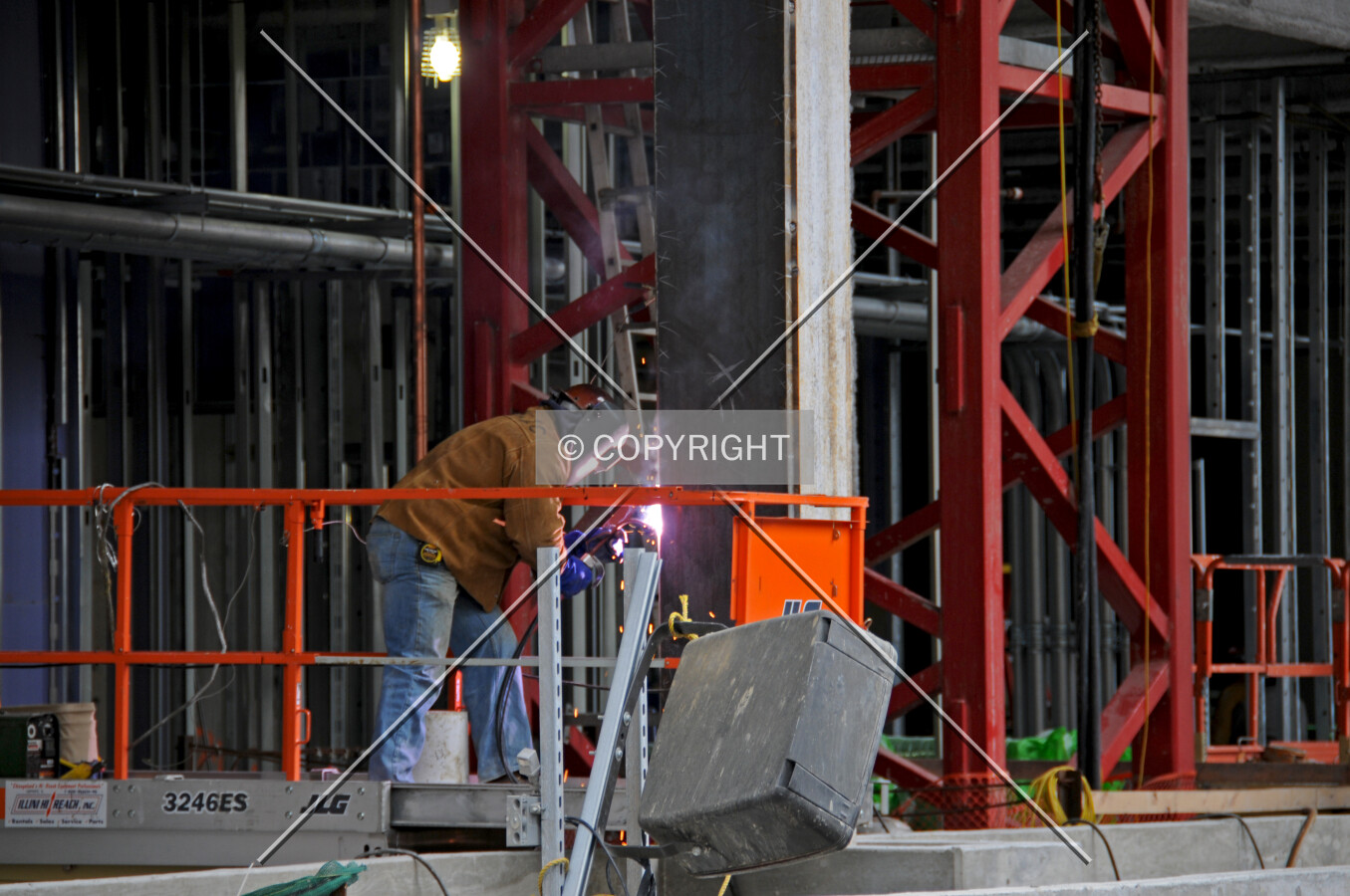 Worker welding a column on the north side of the entry level