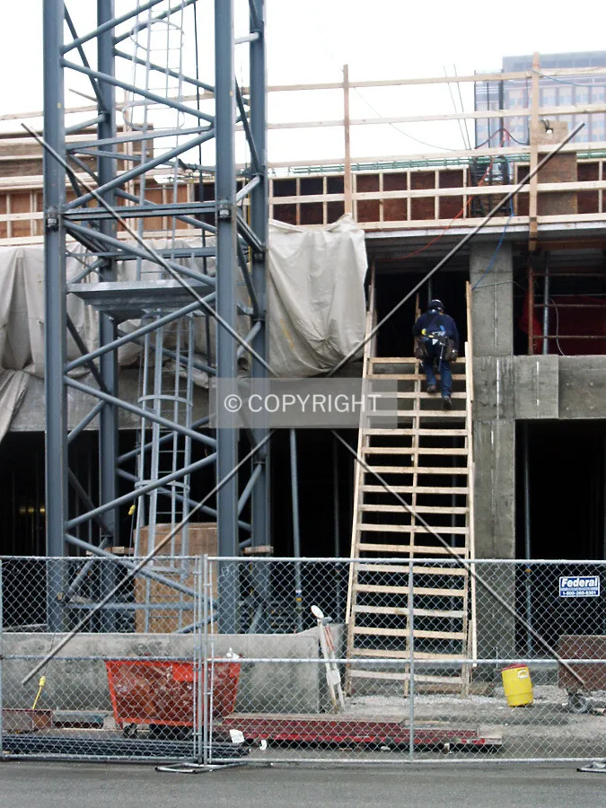 Worker climbing a ladder to the 2nd floor