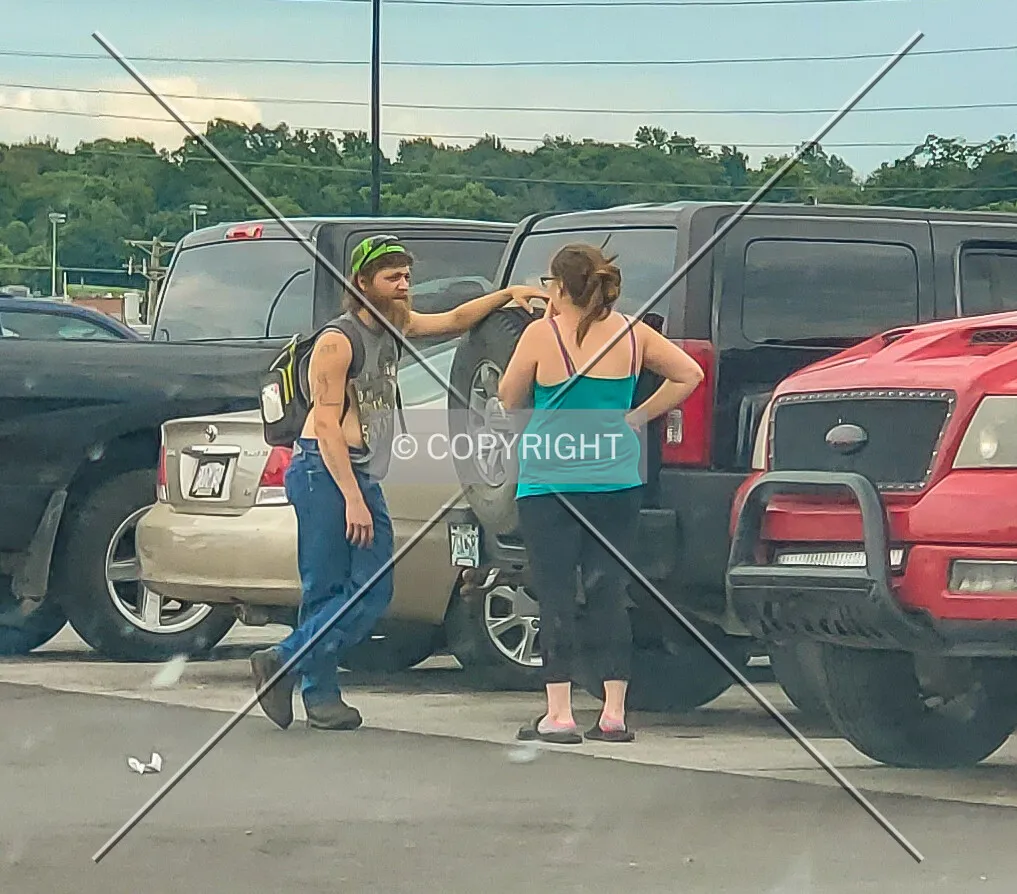 Two people having a cigarette outside before leaving Walmart; June 27, 2020