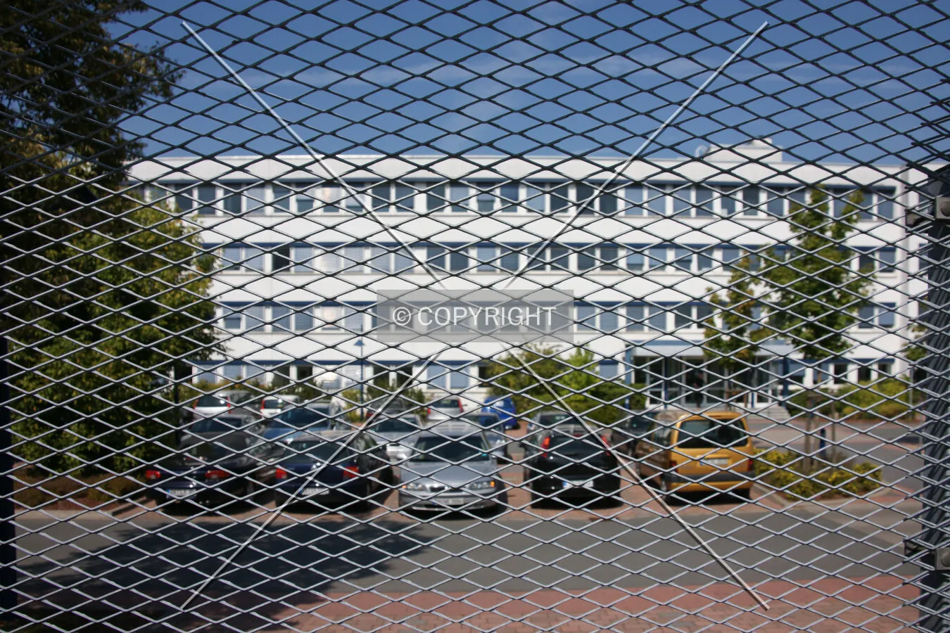 Looking on an office building through a fence