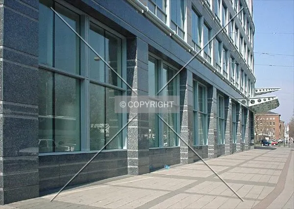 View along the ground level facade of low-rise wing