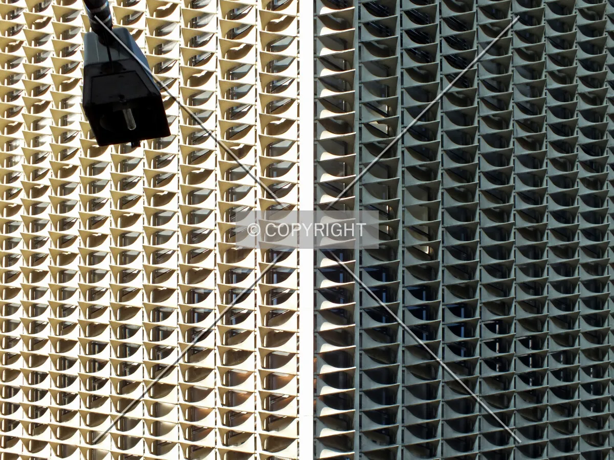A street lamp in front of the repetitive facade elements