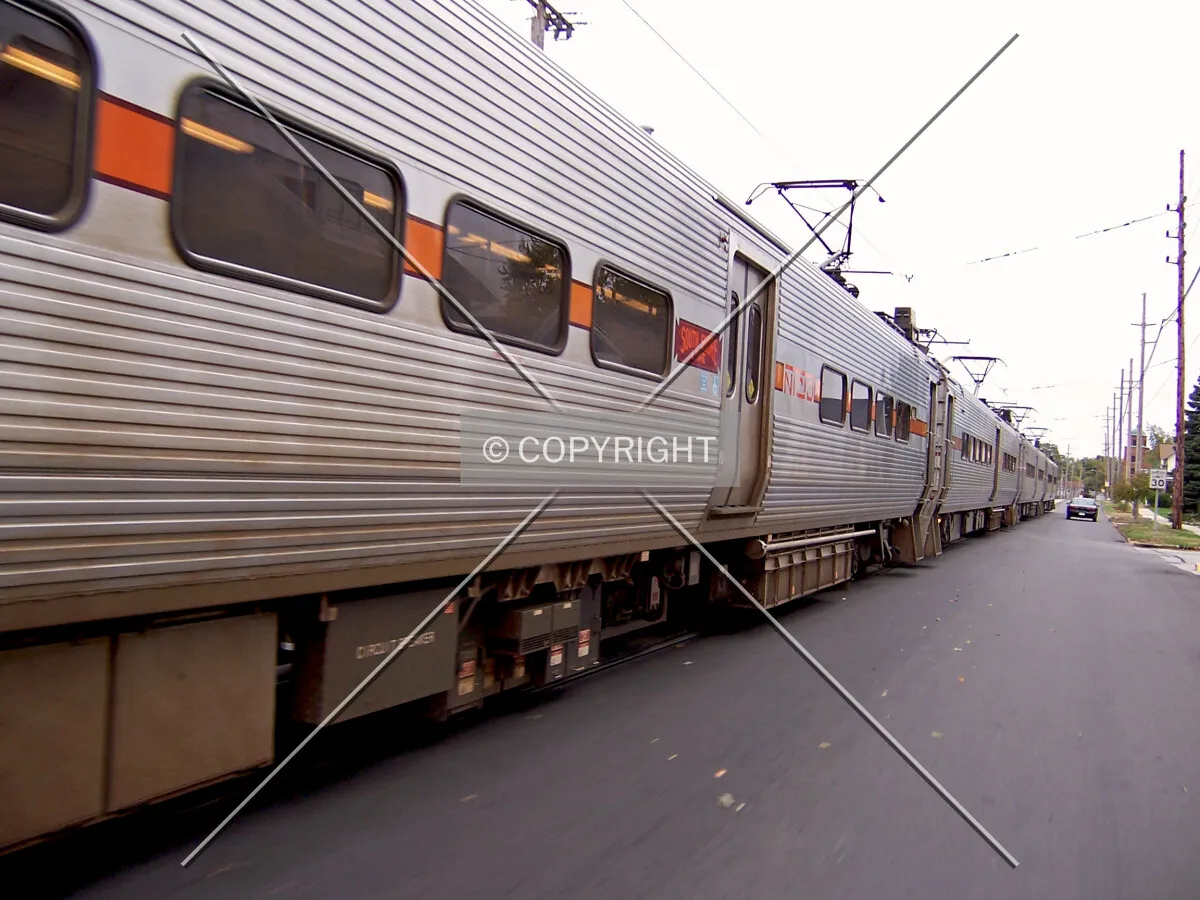 South Shore train running eastbound down the center of 11th Street