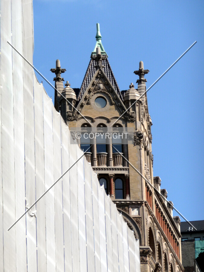Top of the building peeks over nearby scaffolding