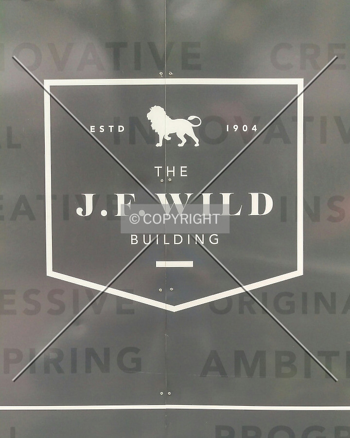 Logo on a construction wall along the front sidewalk; June 27, 2015