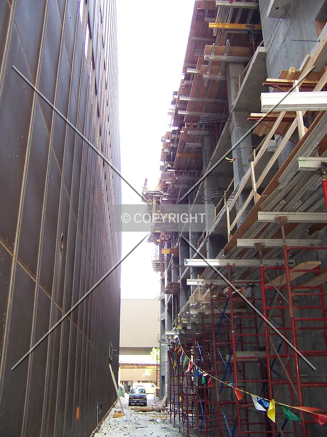Looking north through the gap between the base's western wall and the neighboring Time Life Building