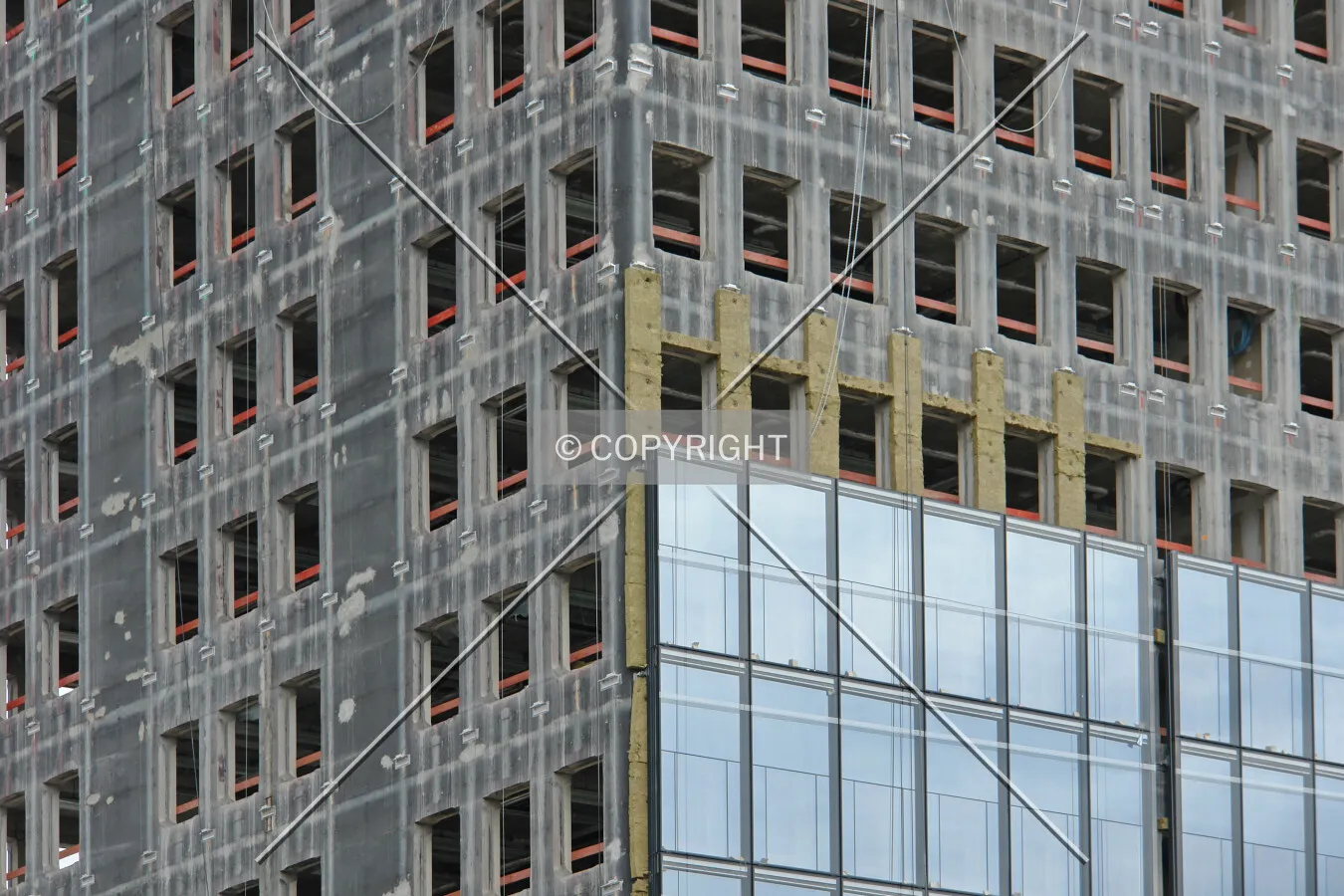 Glass facade and insulation material is brought onto the concrete shell