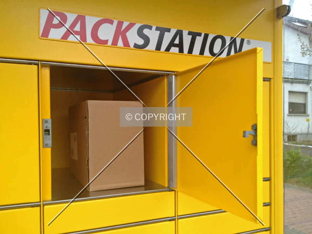 A packstation box is open and someone is picking up a parcel