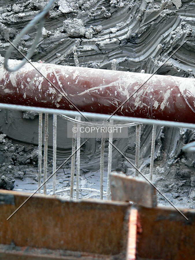 Rebar from a caisson cage, a raker beam and partially excavated clay visible