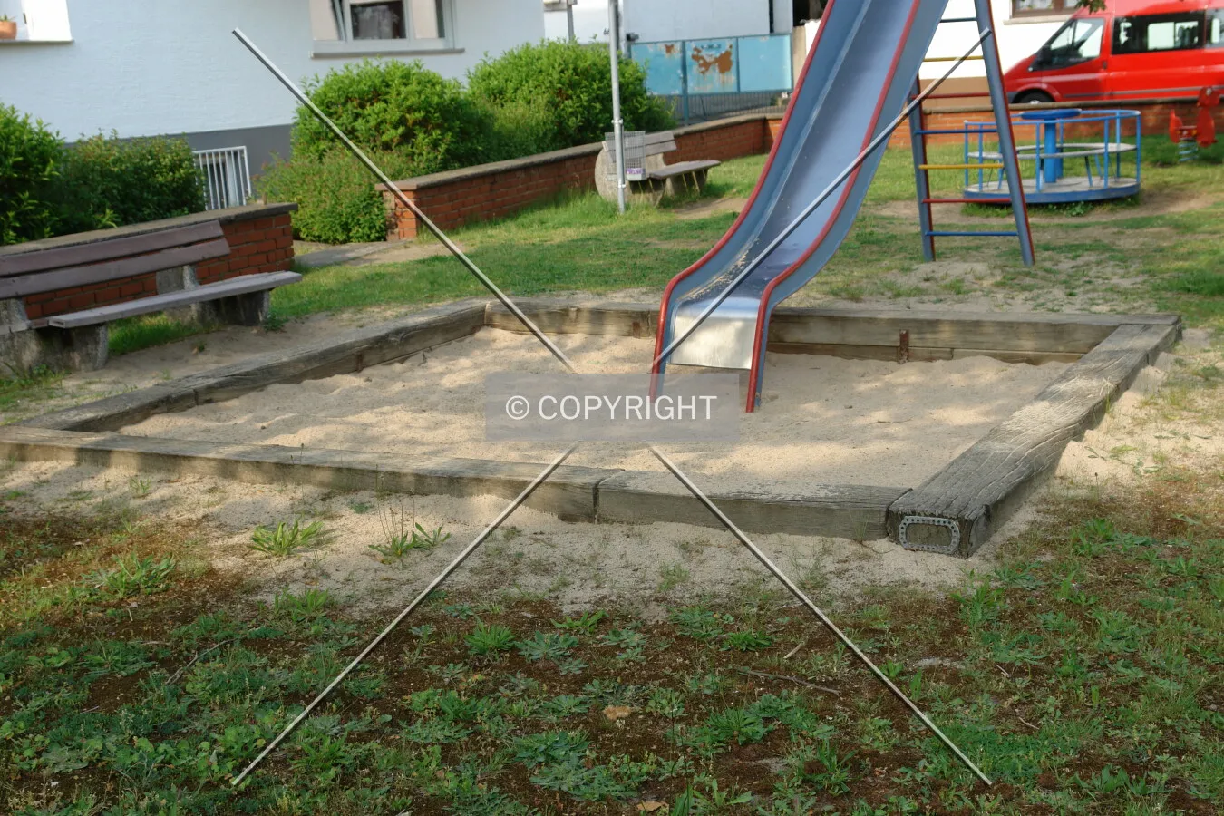 A slide leading to a sandbox