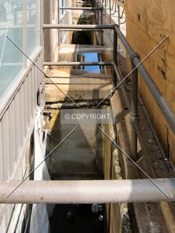 Basement level window wells along Portland Avenue