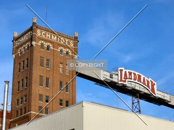 Looking up from West 7th Street, original Schmidt's and newer Landmark names