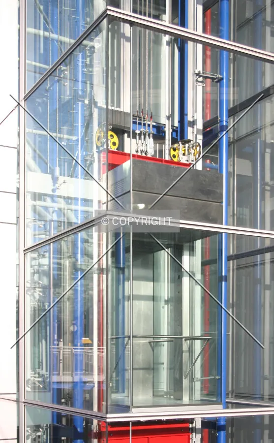 See-through lift shaft with coloured metalwork in typical Richard Rogers style