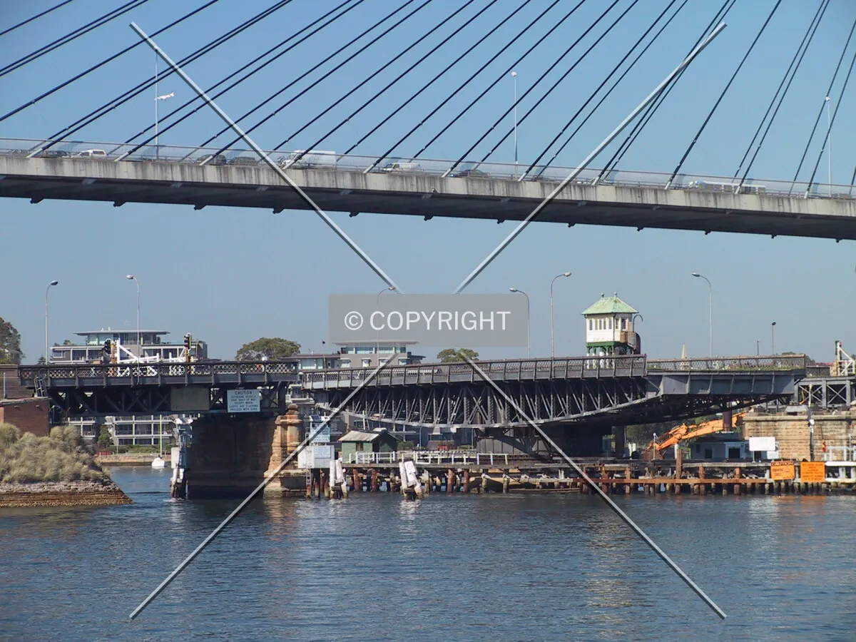 The open swingspan of the former Glebe Island Bridge with the new bridge overhead