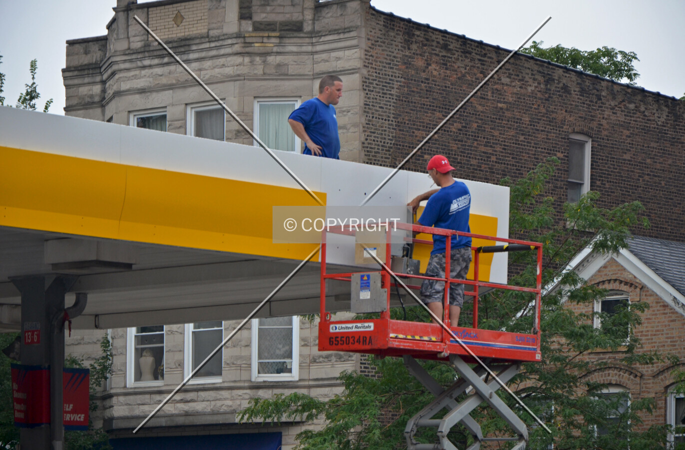 Workers installing new panels during the transition from a Clark branded gas station to a Shell branded gas station. August 22, 2013.