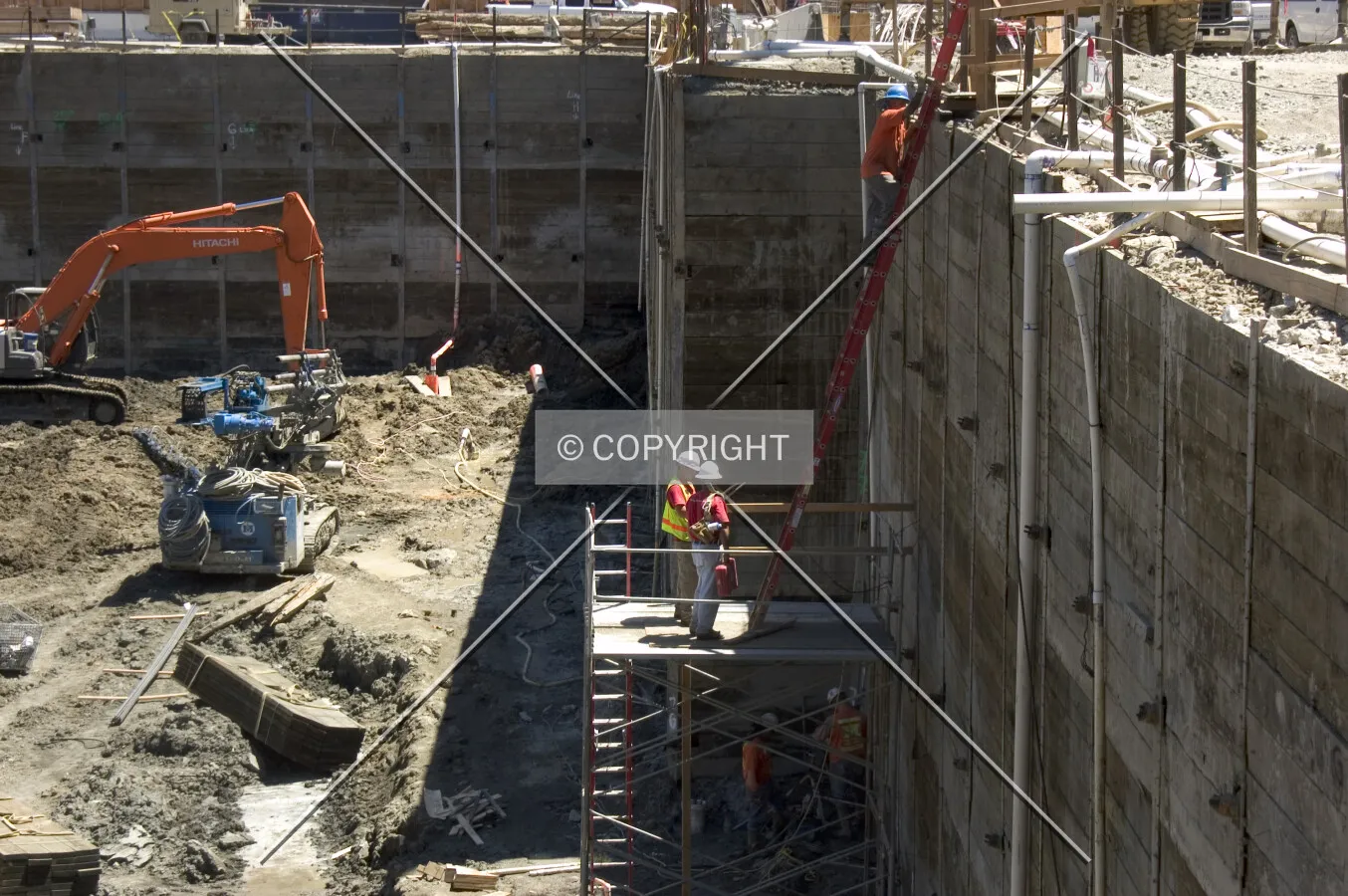 Workmen wait to climb a ladder on the south side of the pit
