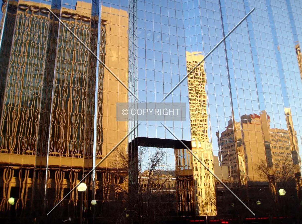 Bank of Oklahoma Tower (left) and more reflect off the north side of the base