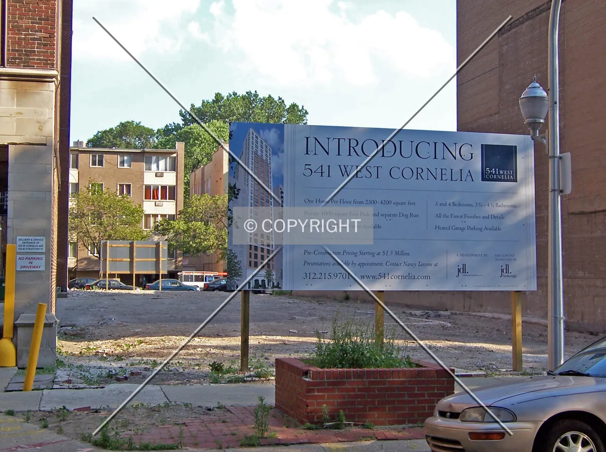 Looking through the block where the narrow tower will rise. An advertising billboard for the tower has been placed at each end of the lot