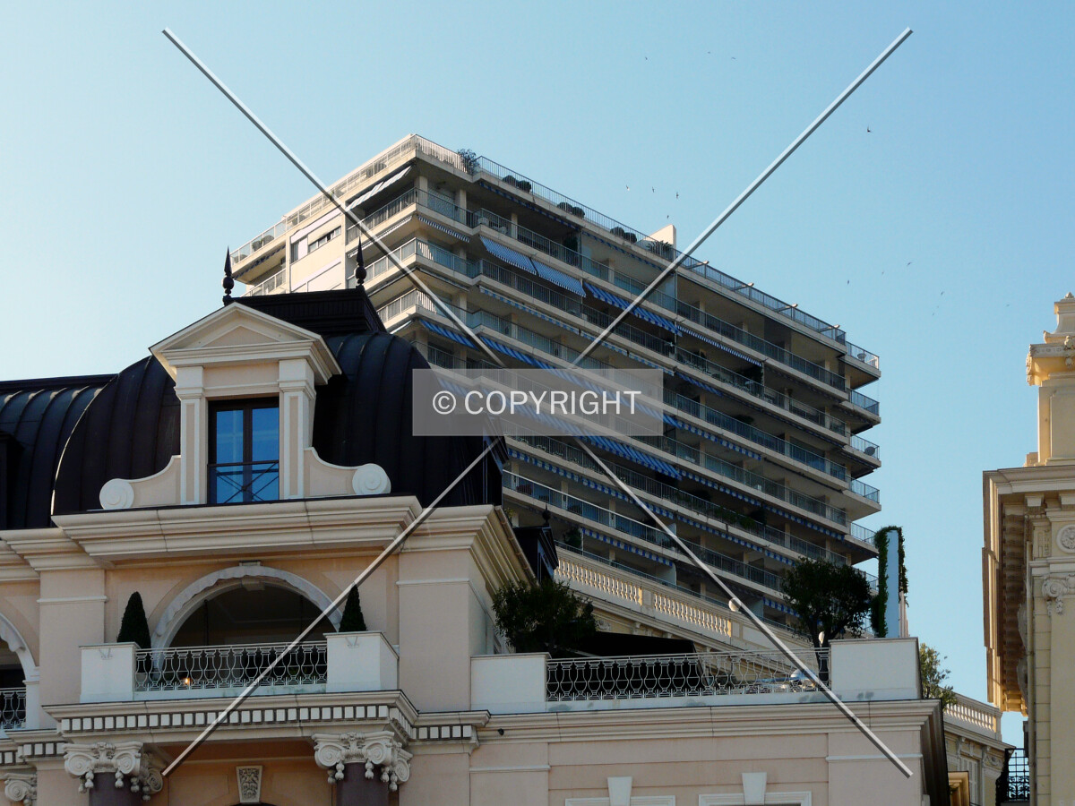 Top from the southeast, partially hidden by a postmodern low-rise building