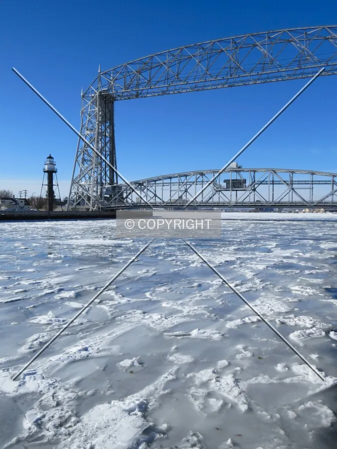 South tower and Rear Range Lighthouse with the frozen Duluth Ship Canal