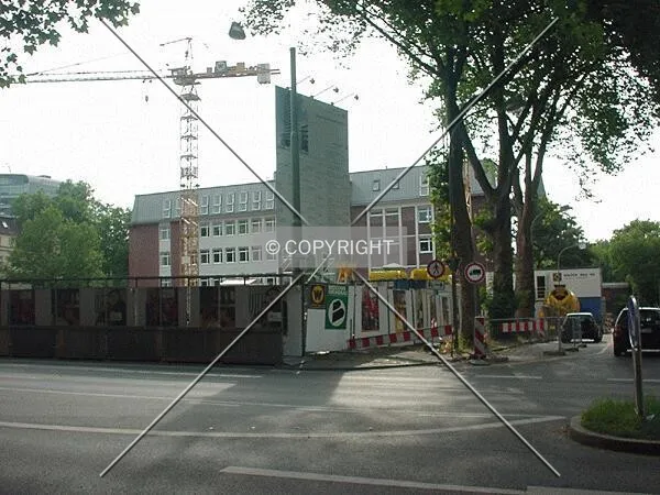Corner view; the existing low-rise building in the background is part of the whole project