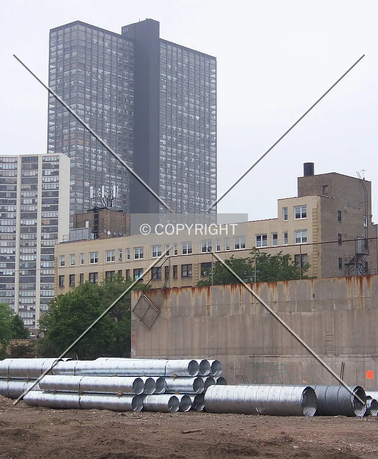 Looking northeast into the site with stacks of caisson liners on the eastern edge of the site