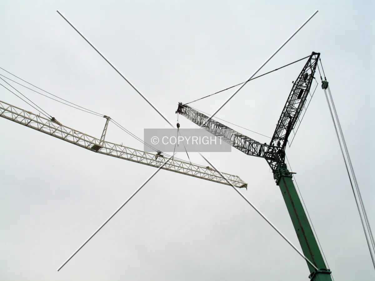 Temporary crane helps hoist the tower-crane sections into place for assembly
