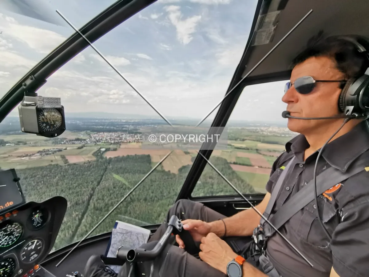 A pilot flying a helicopter
