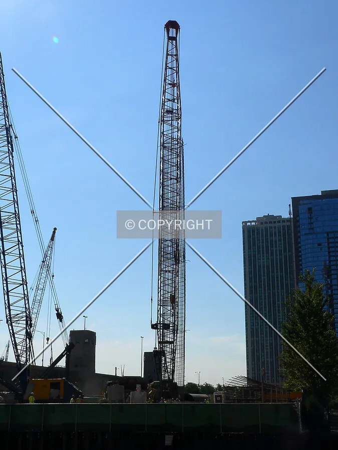 Preparing to lower a rebar cage into a caisson hole