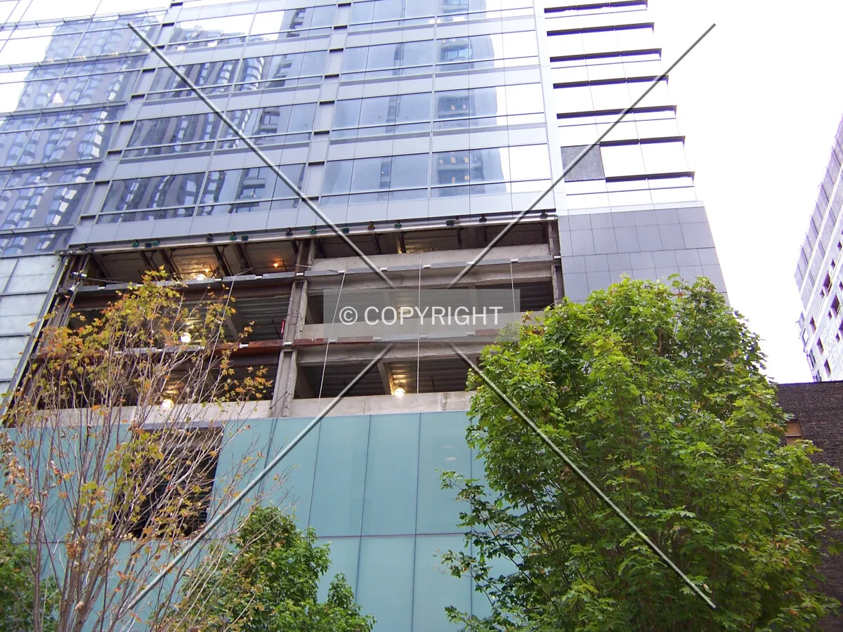 Gap in the finished facade at the southwest corner of the tower, just above the parking levels