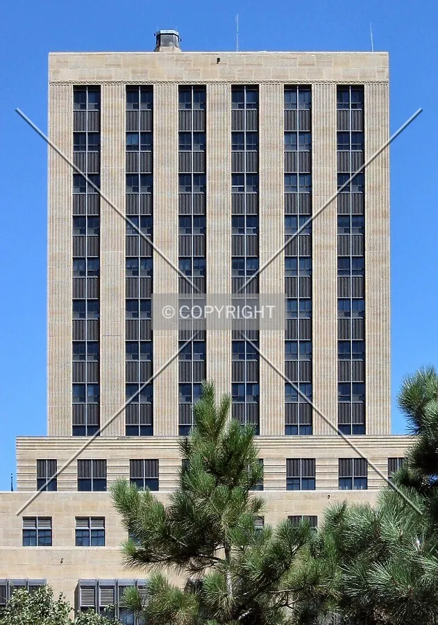 Upper floors of the west facade viewed through Minnesota pine trees before renovation