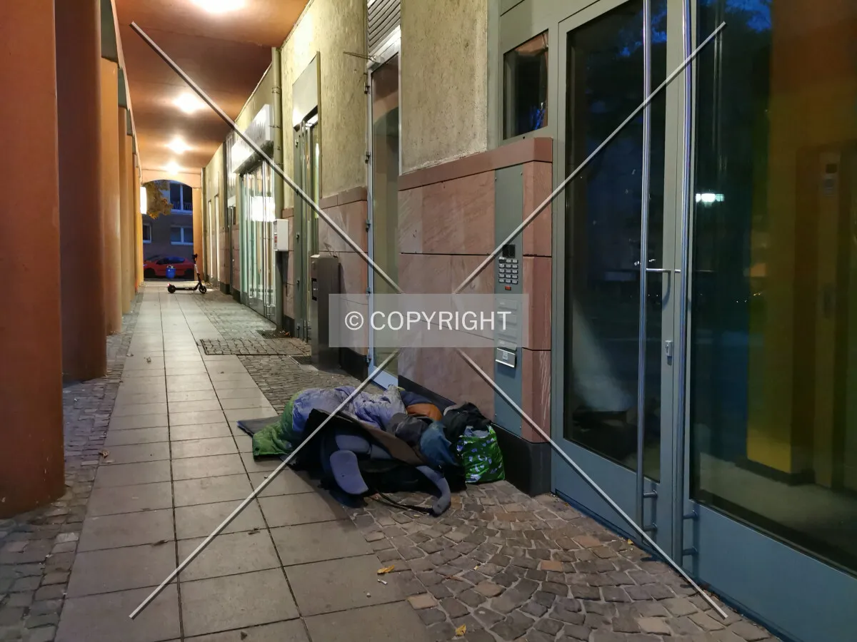 Homeless person sleeping outside at freezing temperatures