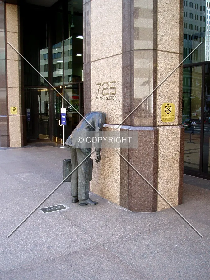 Statue of a frustrated office worker near the north entrance