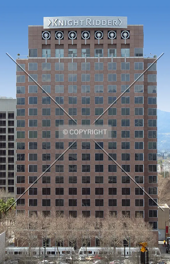 A light-rail line runs along the tower's east side