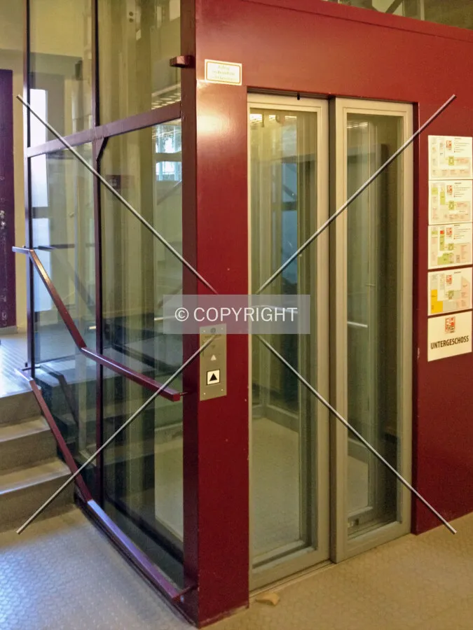 A panoramic elevator inside a building