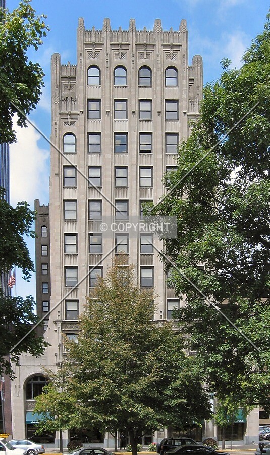 Full east facade through the trees of University Park