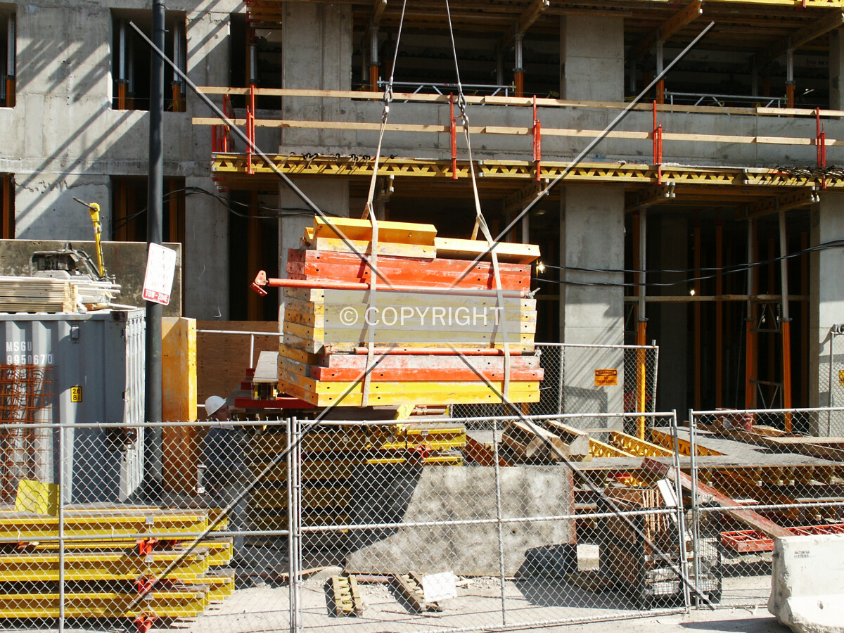 Bundle of formwork pieces being lifted off the ground