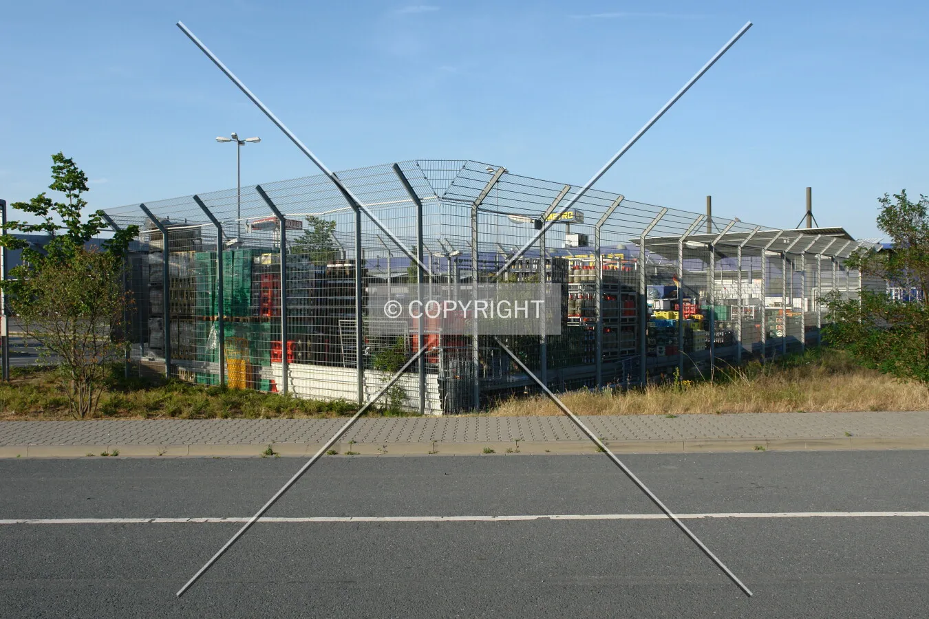 A fenced area containing storage space for crates