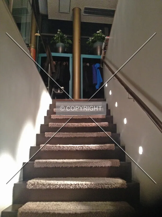 Stairs leading up from the basement to the ground level where the restaurant resides