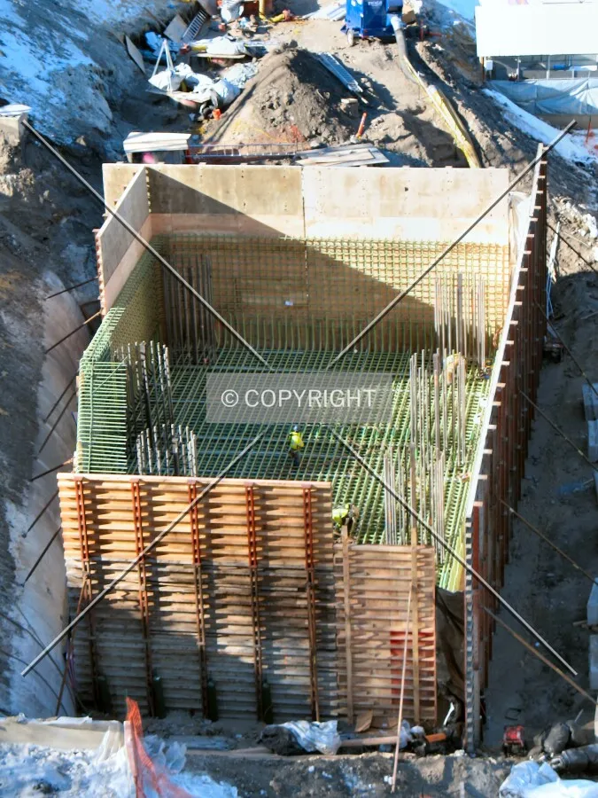 Construction workers inside the massive foundation pit for Pier 2 supporting northbound lanes