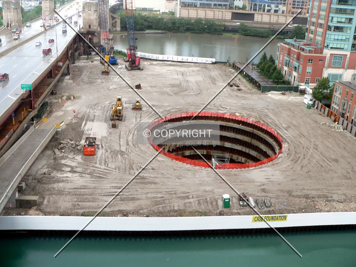 View of the site from a nearby parking garage with a rising river and slip