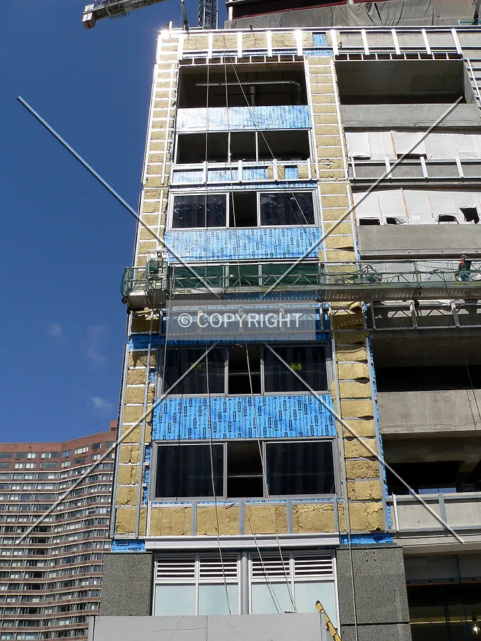 Installing insulation on the concrete in preparation for the facade treatment
