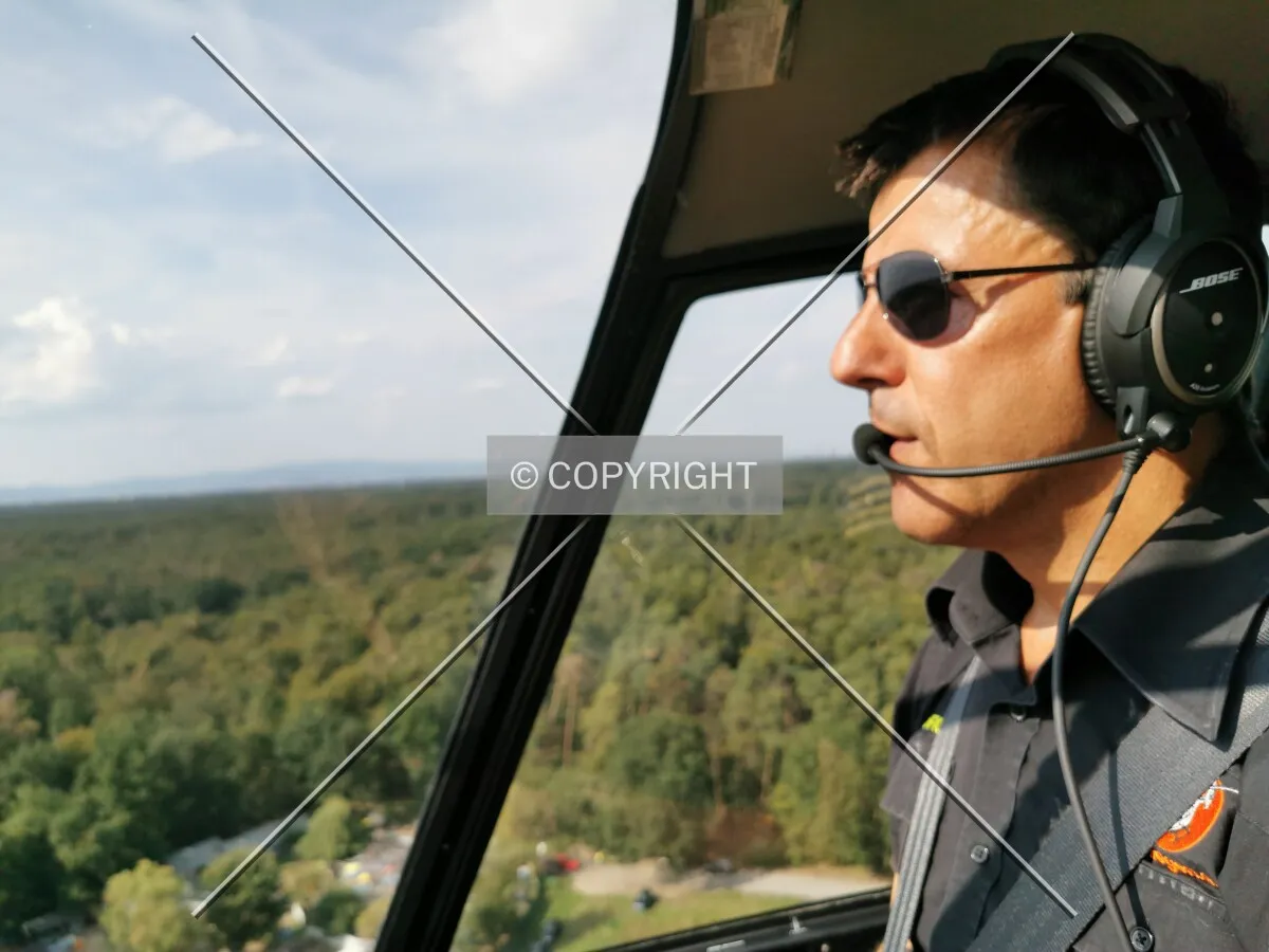 A pilot flying a helicopter