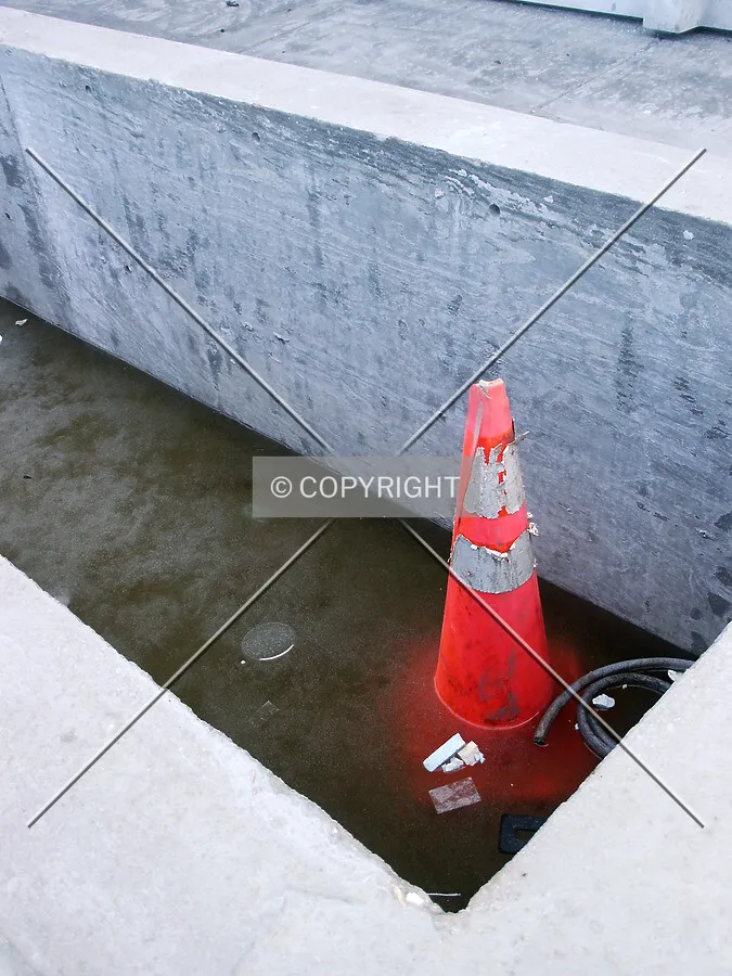 Cone frozen in the planter west of the entrance